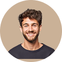 Smiling young man with curly dark hair and beard wearing a black shirt against a beige background.