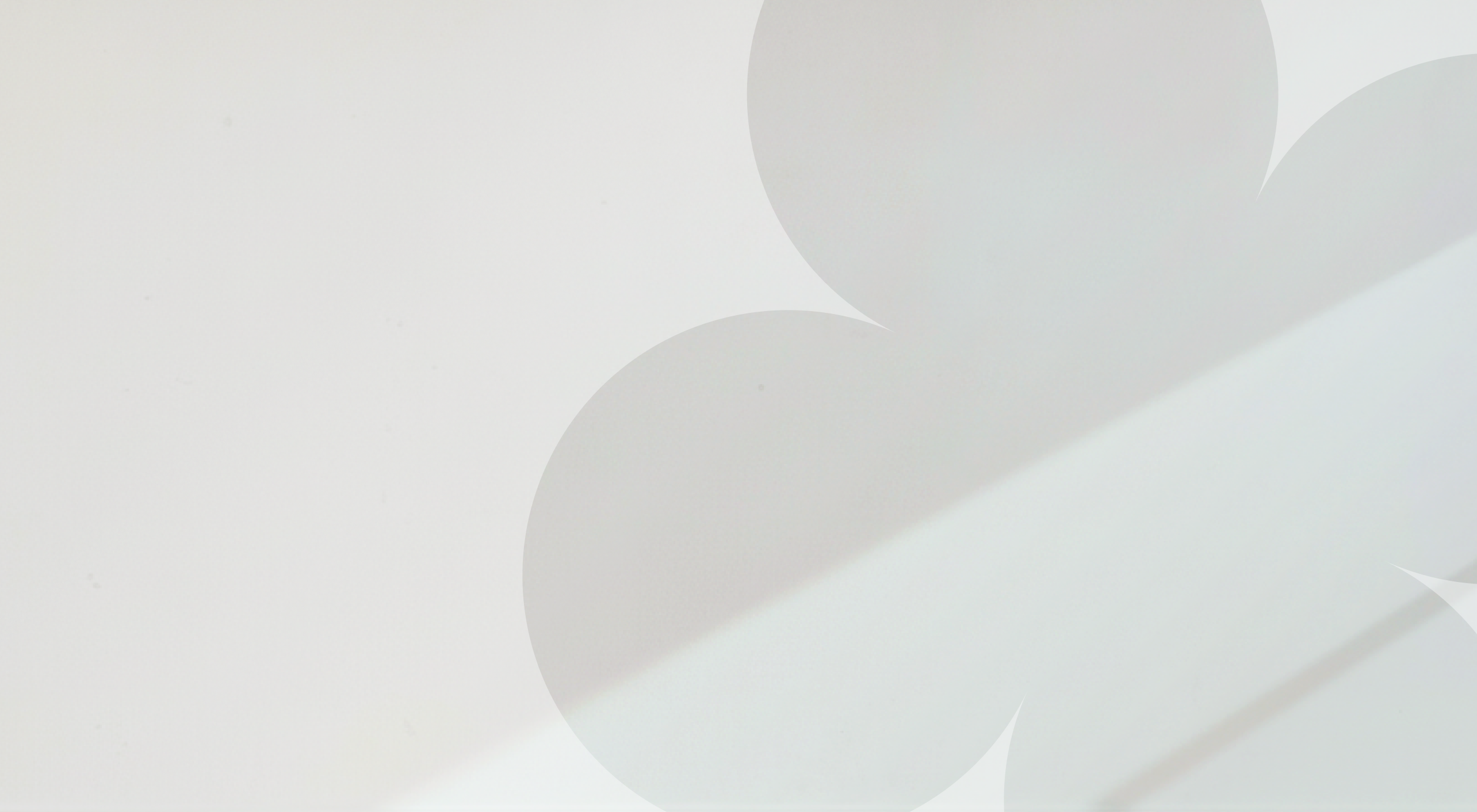 Close-up of a smooth, light-colored surface with soft shadows.